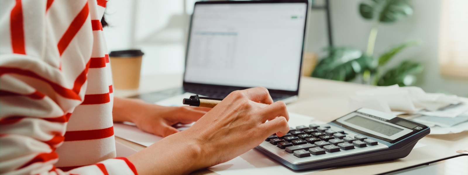 Closeup of woman's hand typing on calculator to estimate her minimum escrow balance